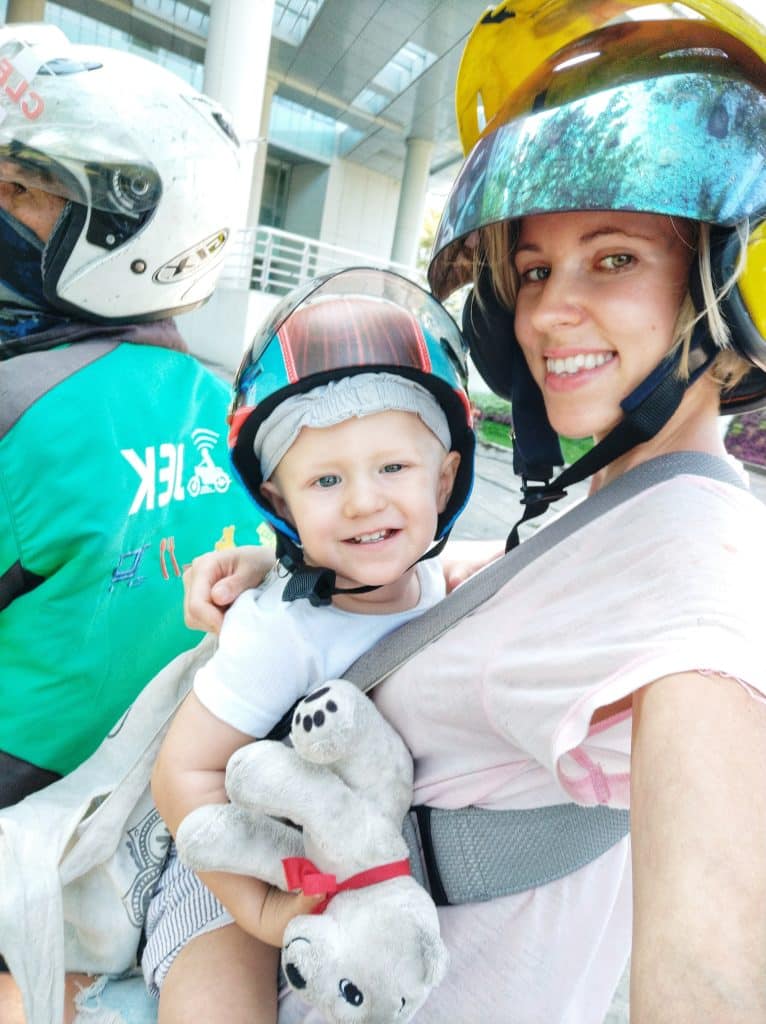Expat mum and baby son riding scooter