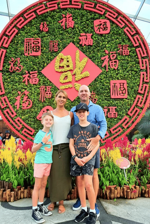 The Zubak family together in front of a Balinese Chinese New Year art piece.