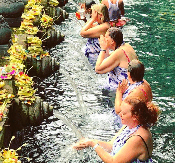 Jules Thomson’s Indah Escapes Tour Group at the Tirta Empul temple, a Hindu Balinese water temple.