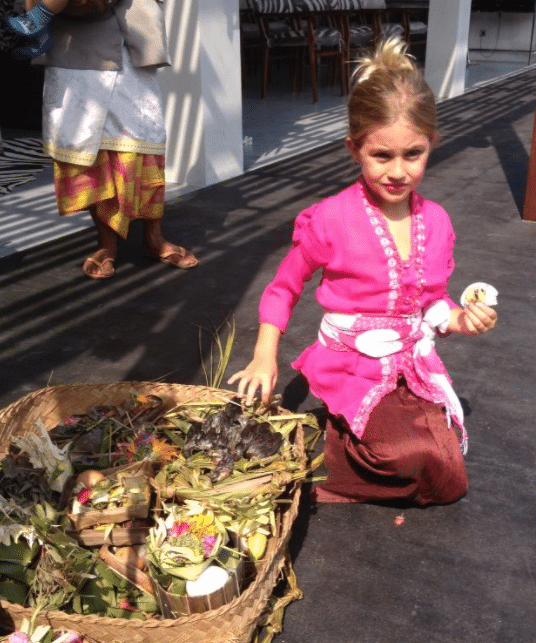 Lee Anna’s daughter, Shanti, dressed in traditional Balinese kebaya and participating in a local Balinese ceremony.