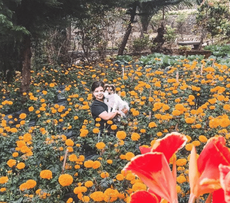 Karlie’s daughter holding the family dog, surrounded by wildflowers in Bali.