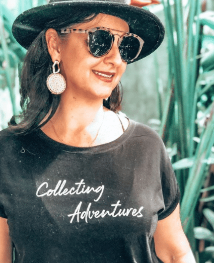 Karlie enjoying Bali, wearing a shirt that reads ‘Collecting Adventures’.