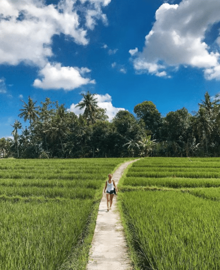Cath walking through rice fields in Canggu