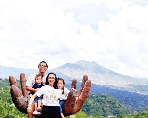 Indonesian family posing on hill in Kintamani, Bali, Indonesia