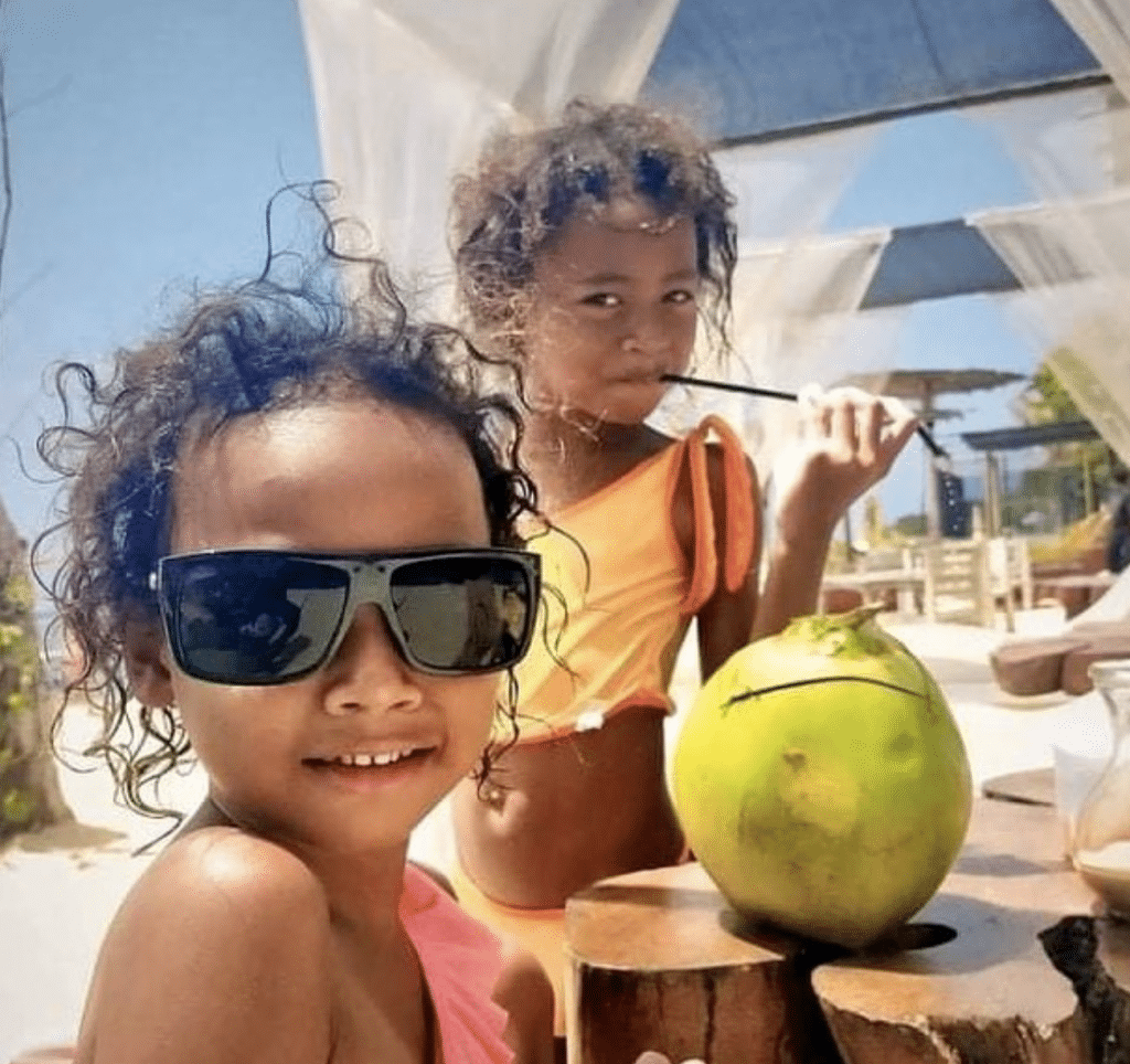 Kids drinking coconuts in Bali