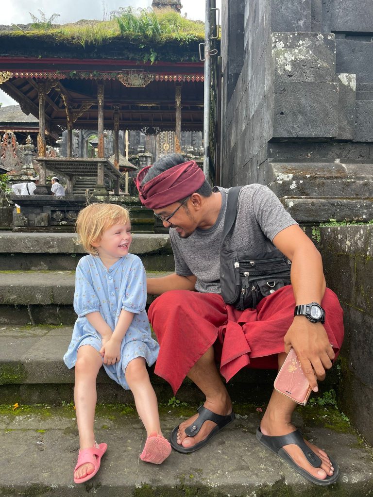 Balinese man with foreigner toddler sharing a laught together