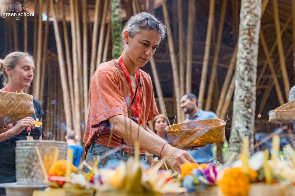 Mother helping with Balinese offering at the Green School